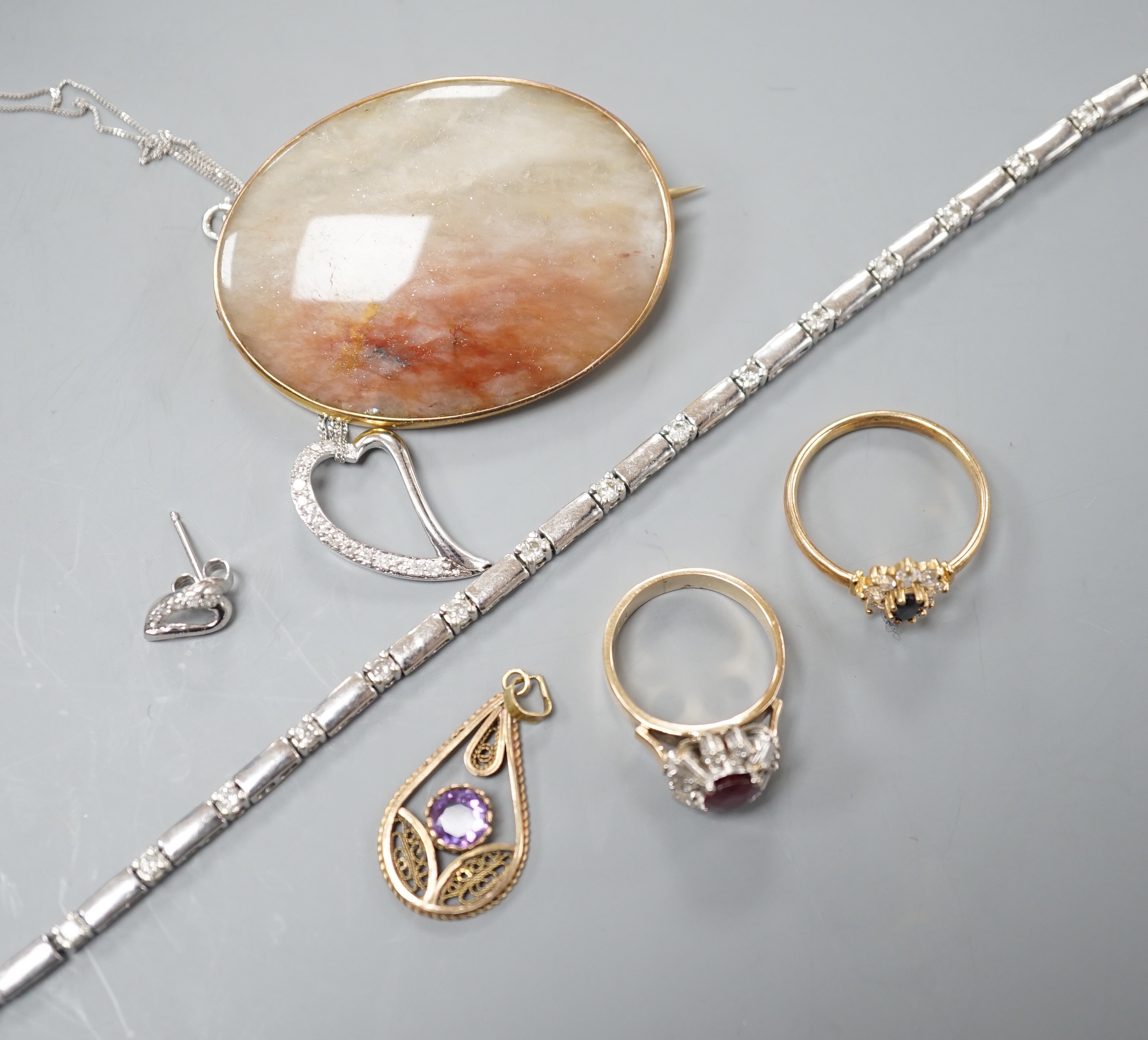 A 9kt white metal and diamond set bracelet, a 9ct mounted agate brooch, two rings including 18k, two pendants and a pair of modern diamond set ear studs.